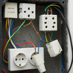 Close-up of common electrical issues causing inspection failures, including damaged wiring and overloaded sockets