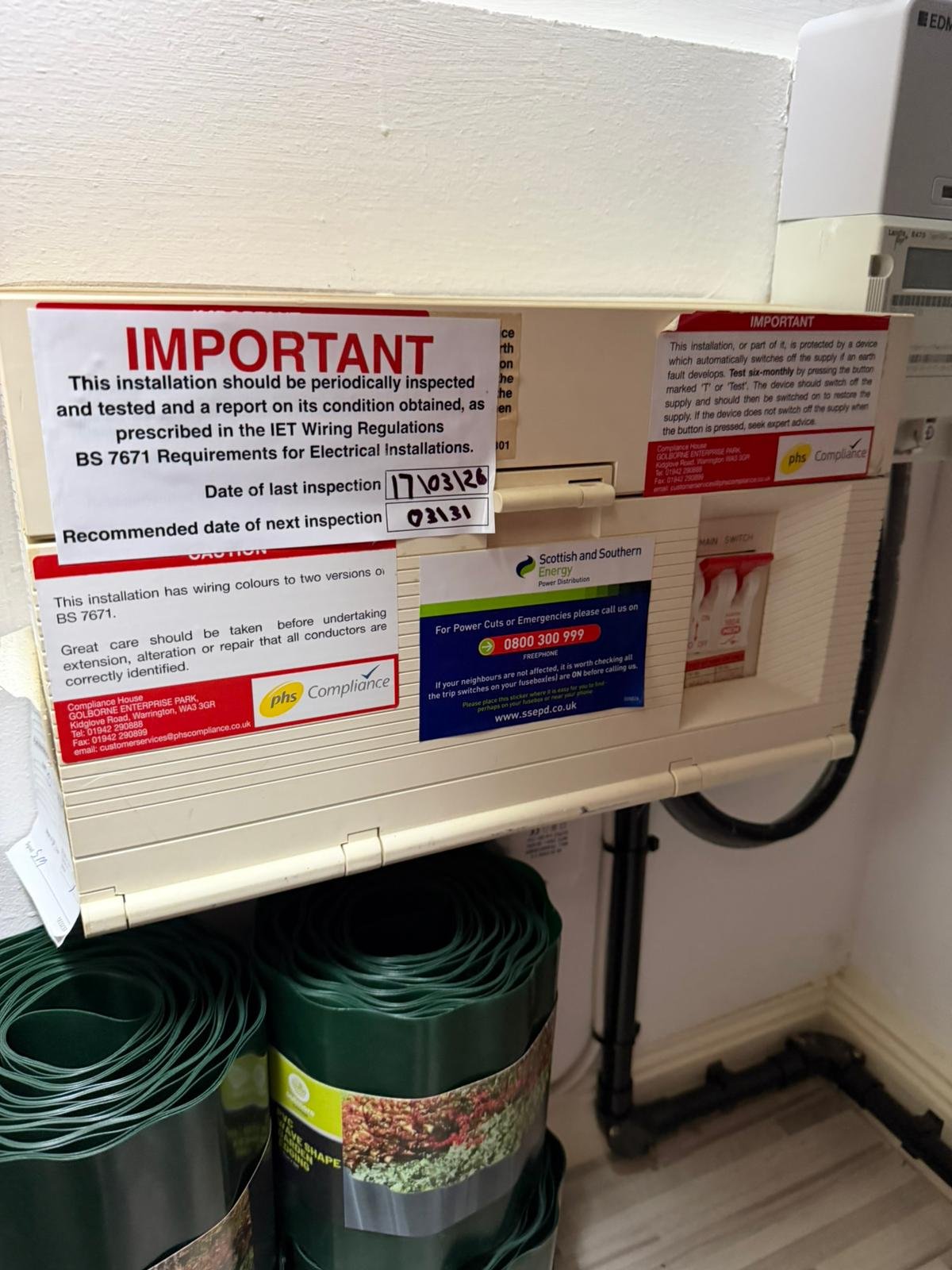 Older consumer unit with EICR labels and power cut information sticker in a Torry flat