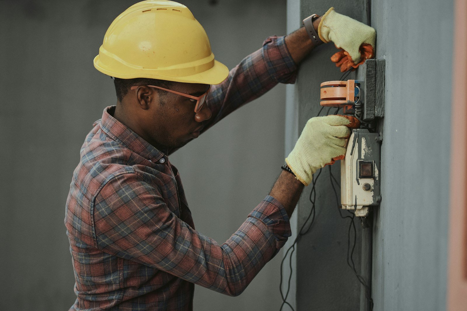 Electrician hardhat working on box in Westhill