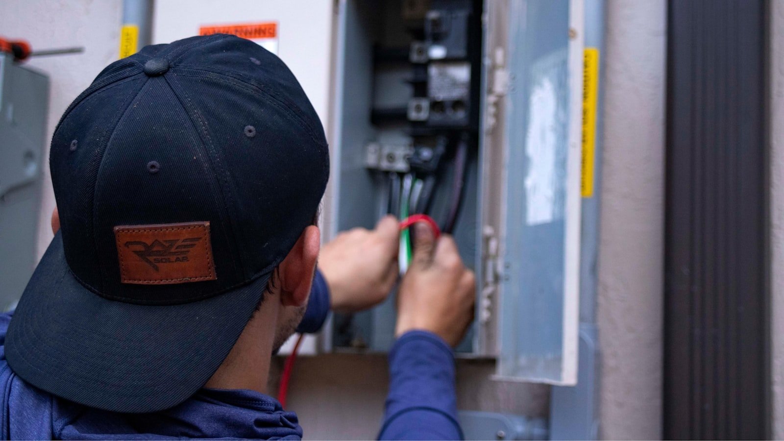 Electrician wiring breaker panel closeup in Westhill