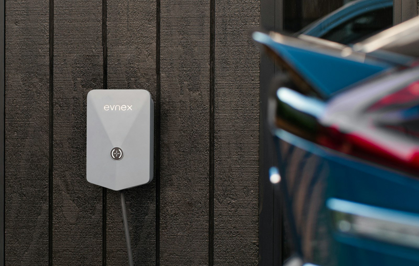 Ev car plugged wall charger driveway in Maryculter