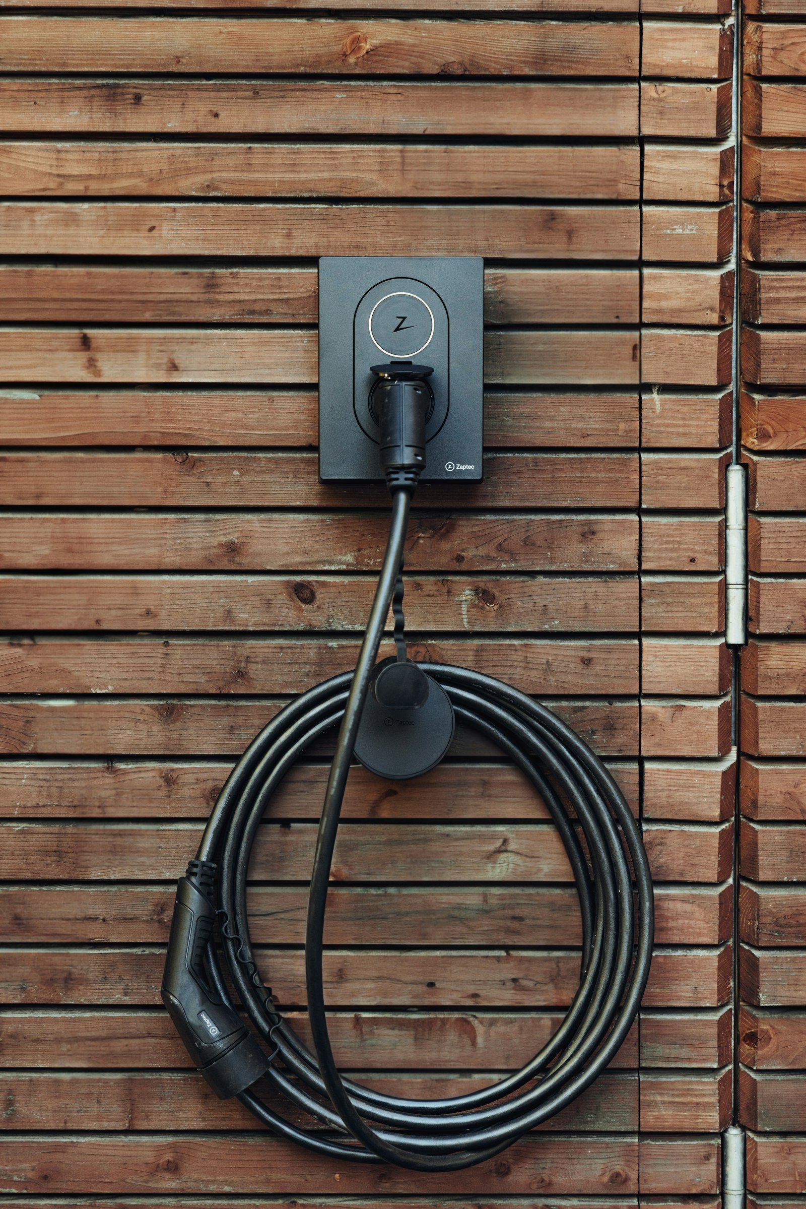 Ev charger cord wood wall in Cults