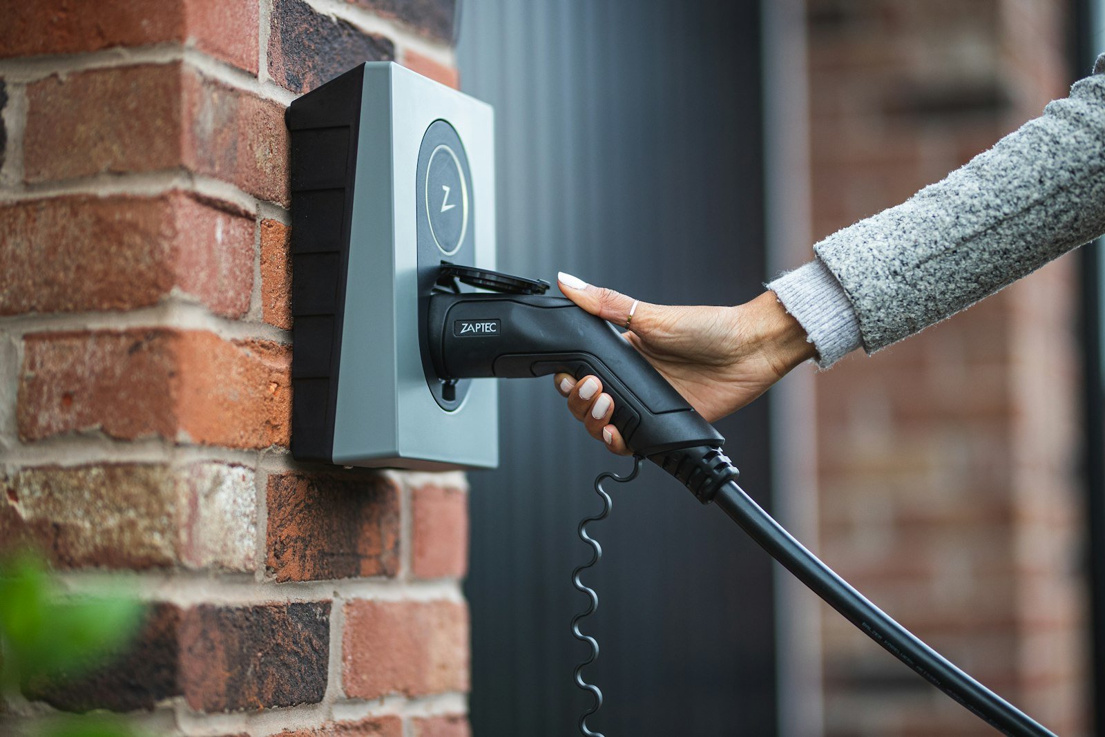 Ev person charging electric car in Kingswells