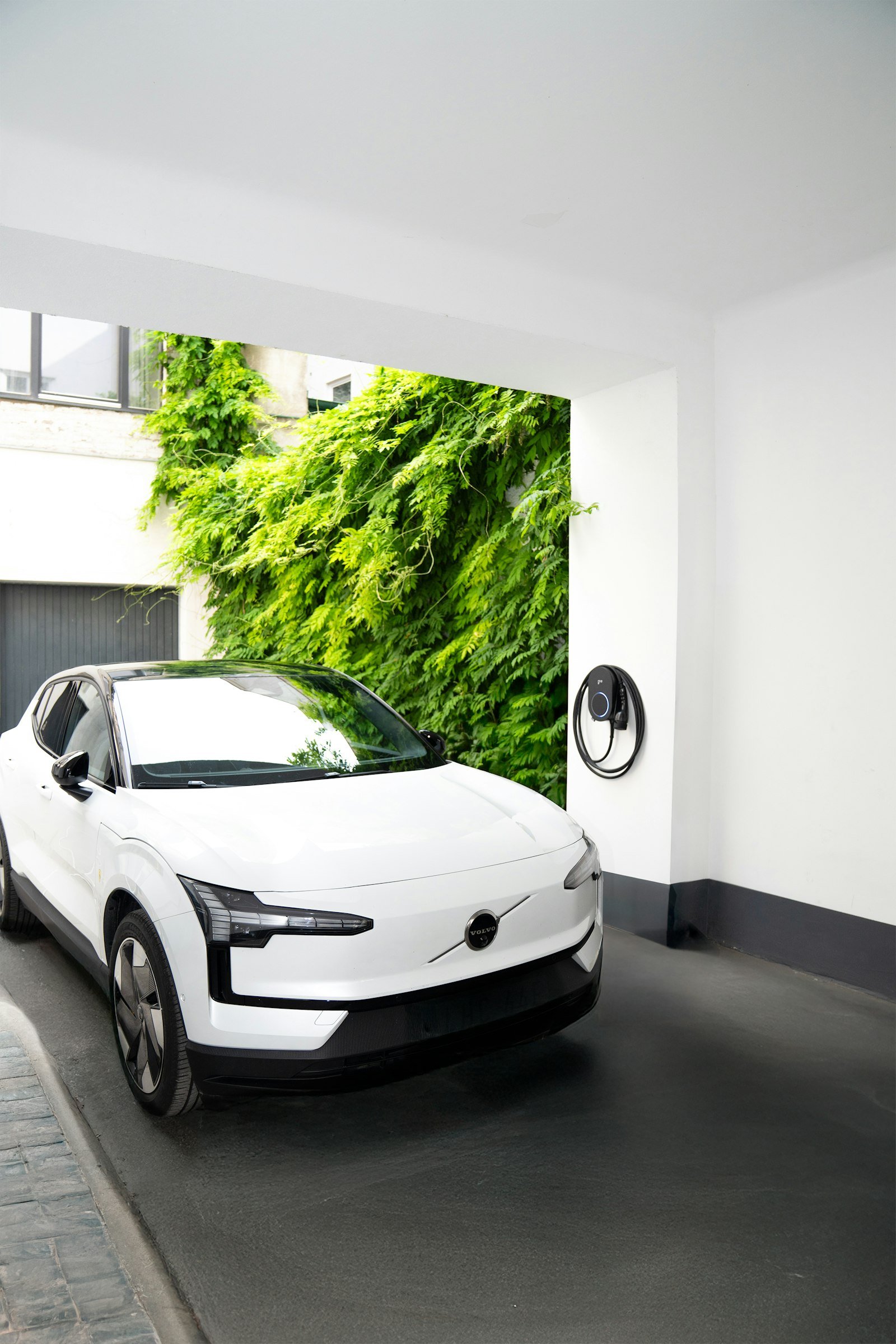 Ev white charging station green wall in Kingswells