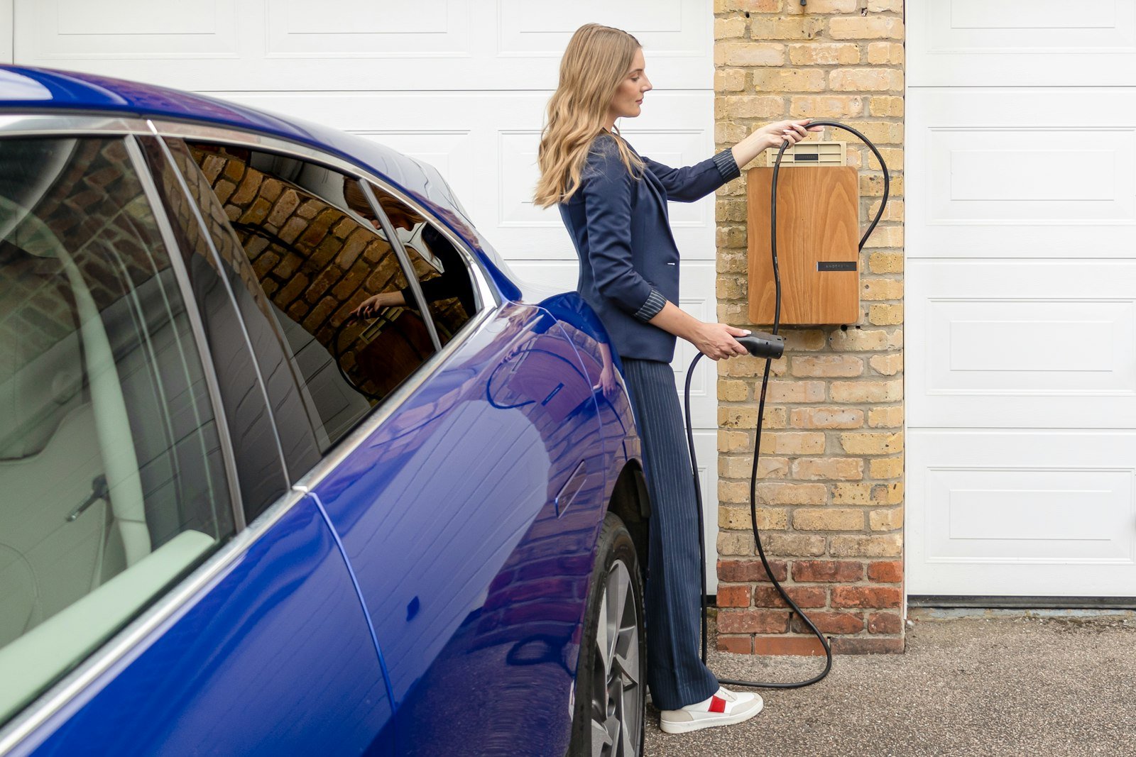 Ev woman charging electric car in Westhill