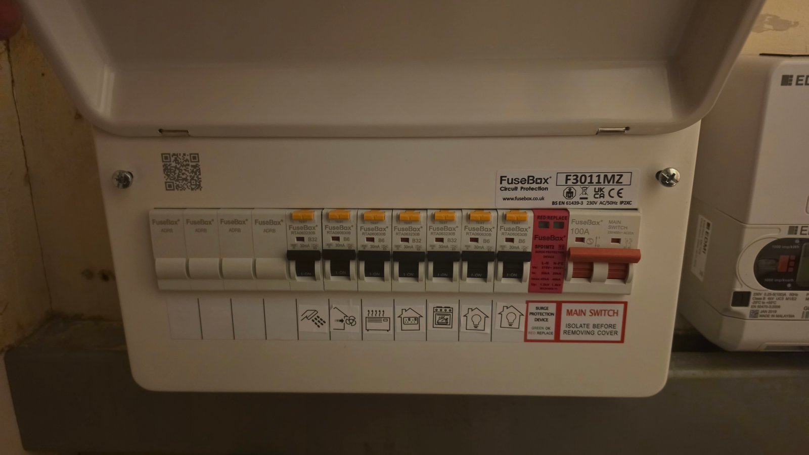 Close up of RCBOs in a consumer unit beside a smart meter in a Queens Road villa