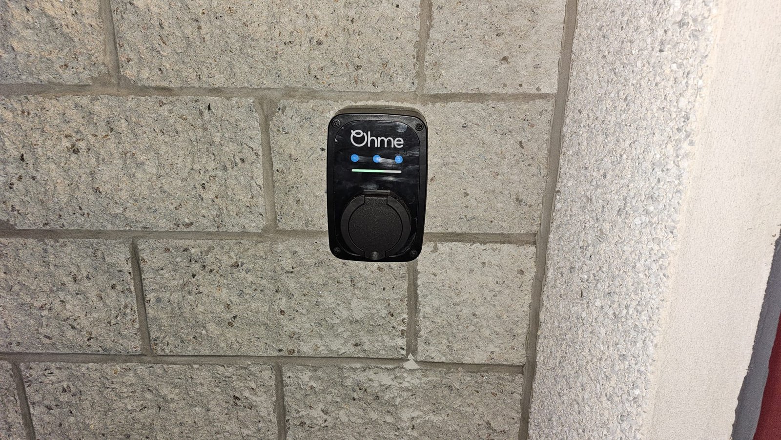 Ohme ePod EV charger installed on a block wall in Dyce