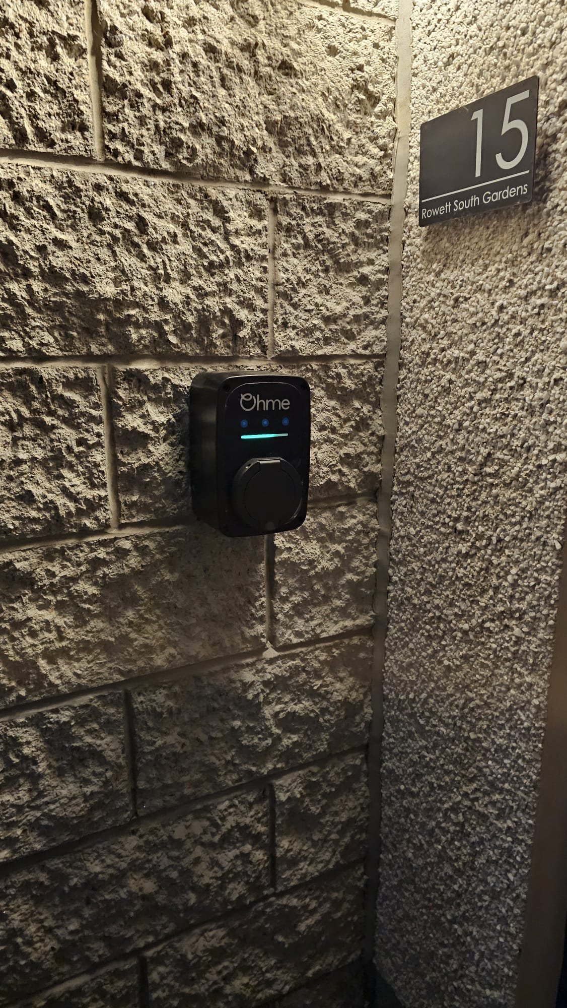 Ohme EV charger installation at an Aberdeenshire home, mounted on a stone-clad porch wall. NICEIC and OZEV approved fit