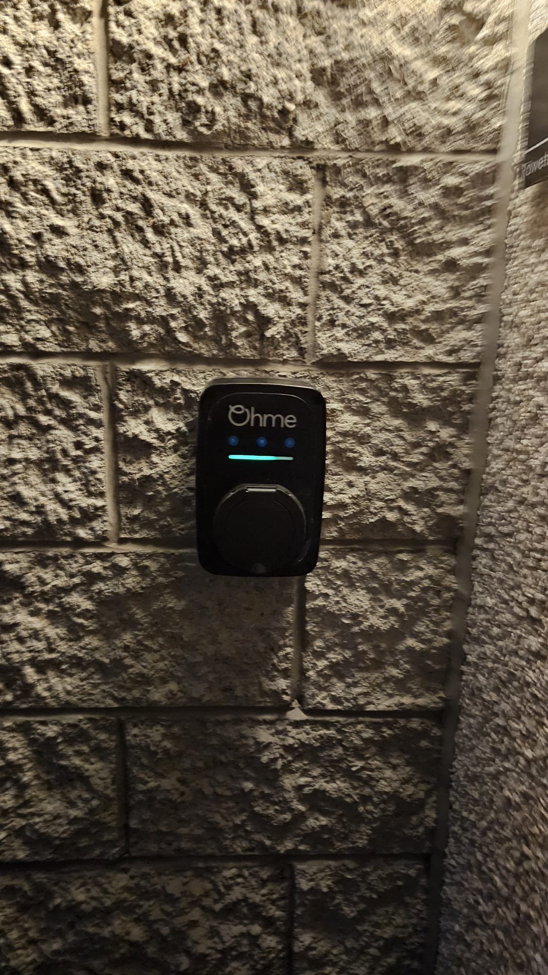 Side-angle view of the Ohme home EV charger installed in Aberdeen by Faithful Spark Electricians