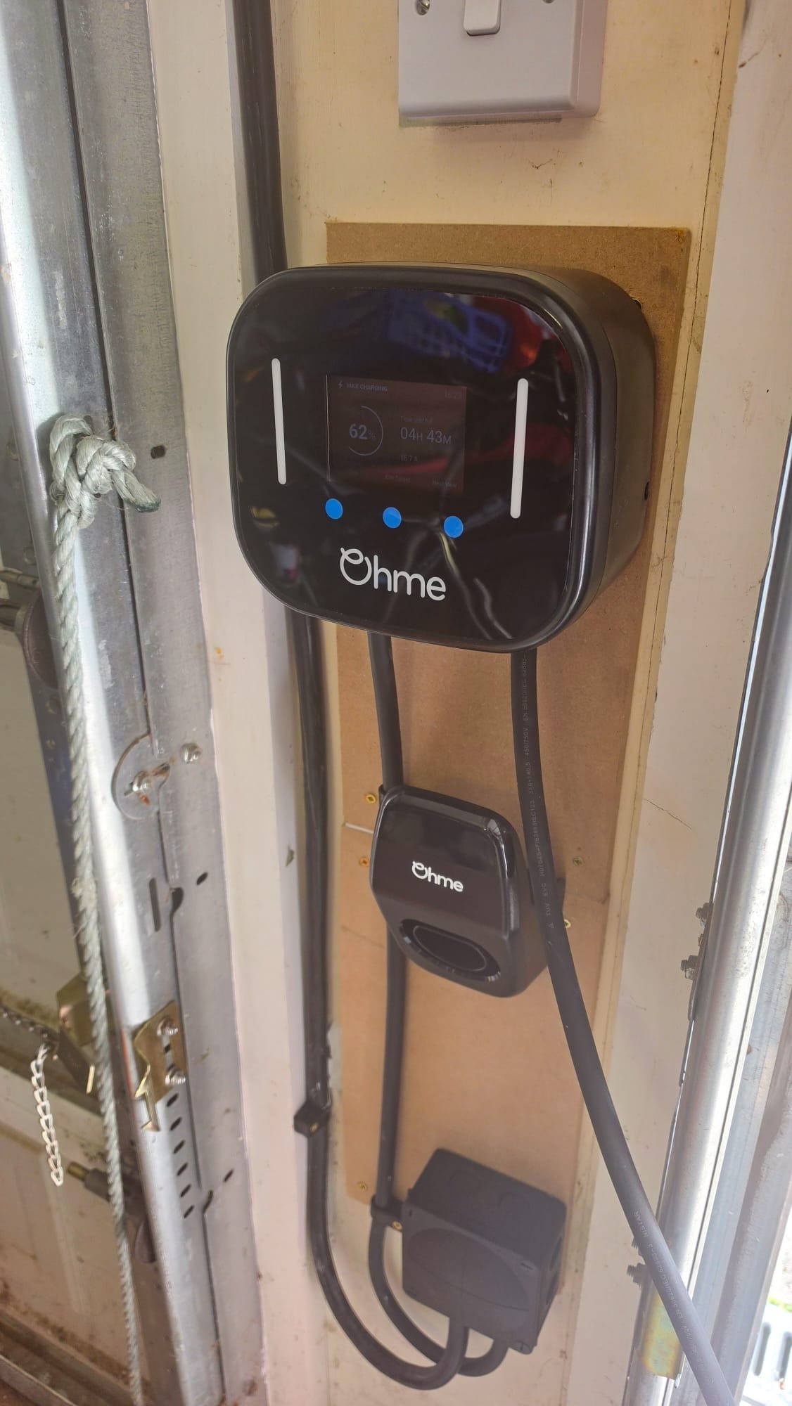 Ohme Home Pro EV charger charging in a Danestone garage doorway