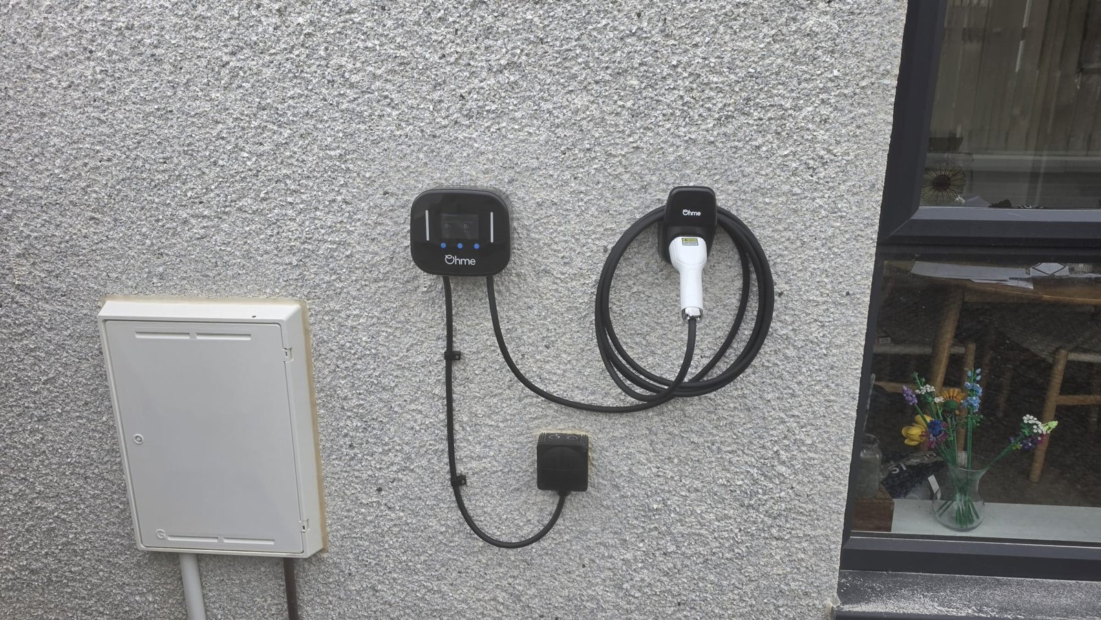 Ohme EV charger installed on outdoor render wall in Aberdeenshire by Faithful Spark Electricians