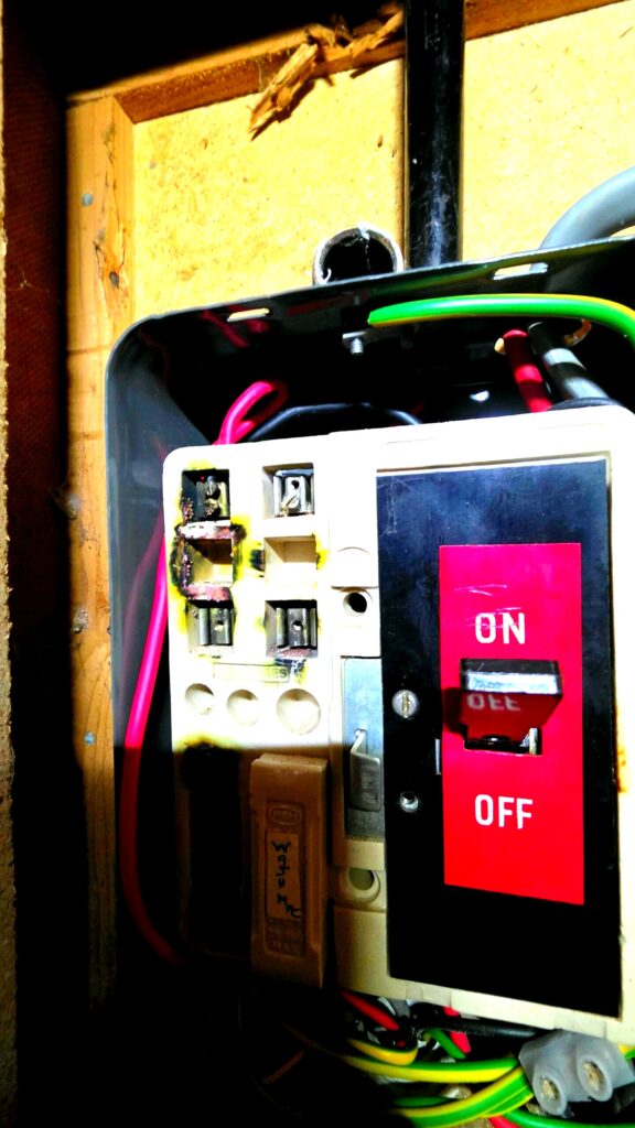 Burnt and damaged consumer unit found during EICR inspection in Aberdeen — immediate danger C1 fault