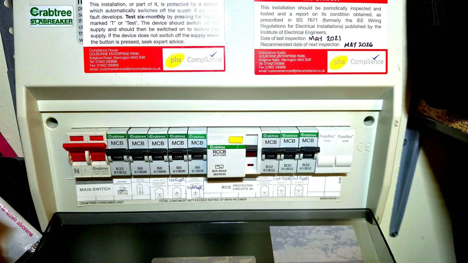 Crabtree consumer unit with EICR inspection labels showing last inspection May 2021 and next due May 2026 — Aberdeen flat