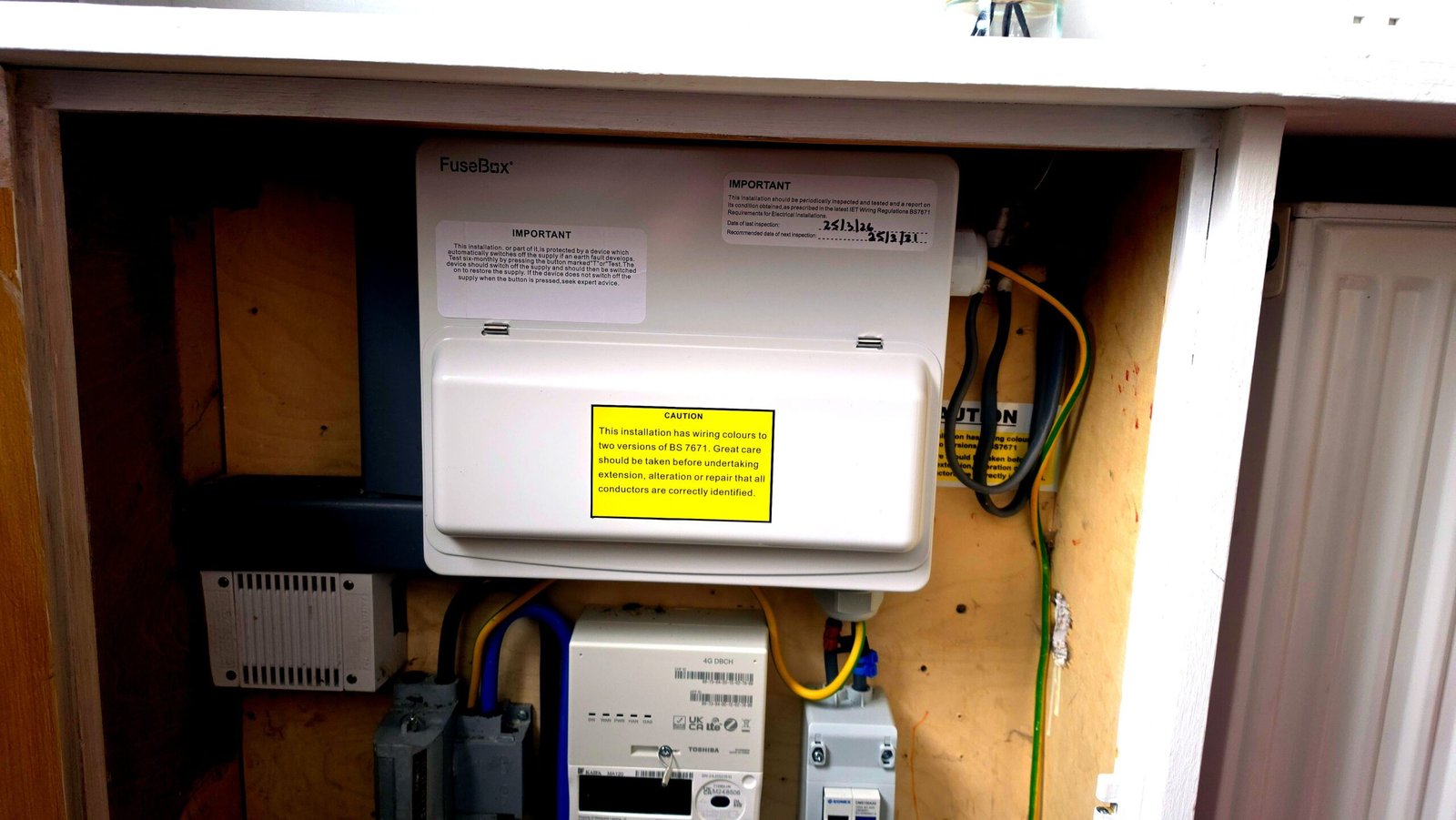 FuseBox consumer unit in a meter cupboard in an Aberdeen flat — typical communal hallway meter setup