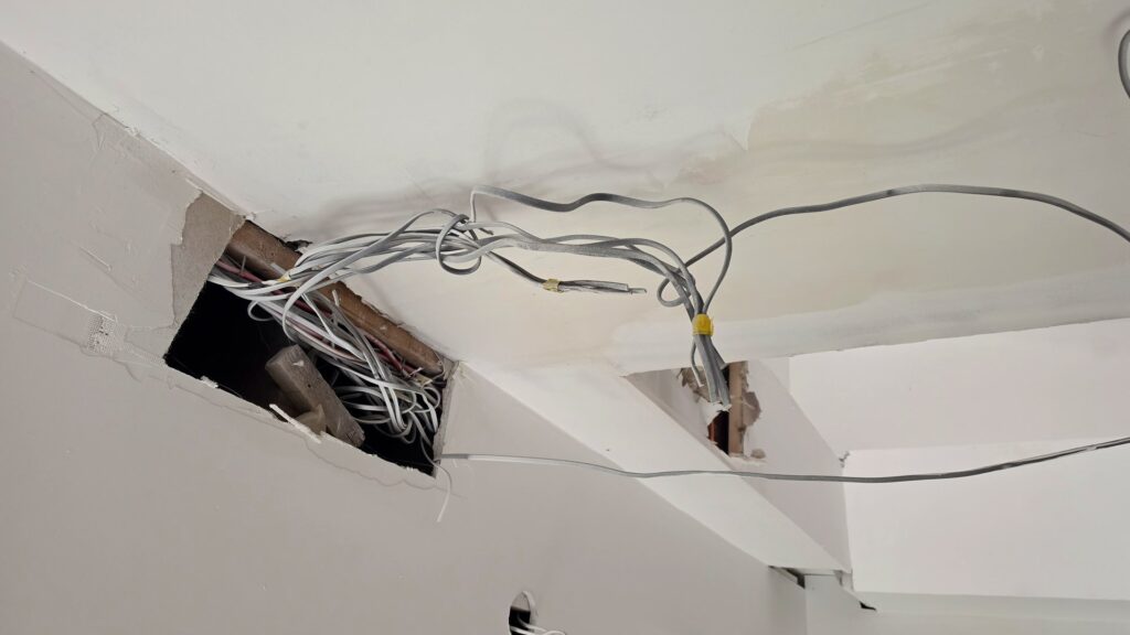 Old meter and consumer unit cupboard before rewire Scotland