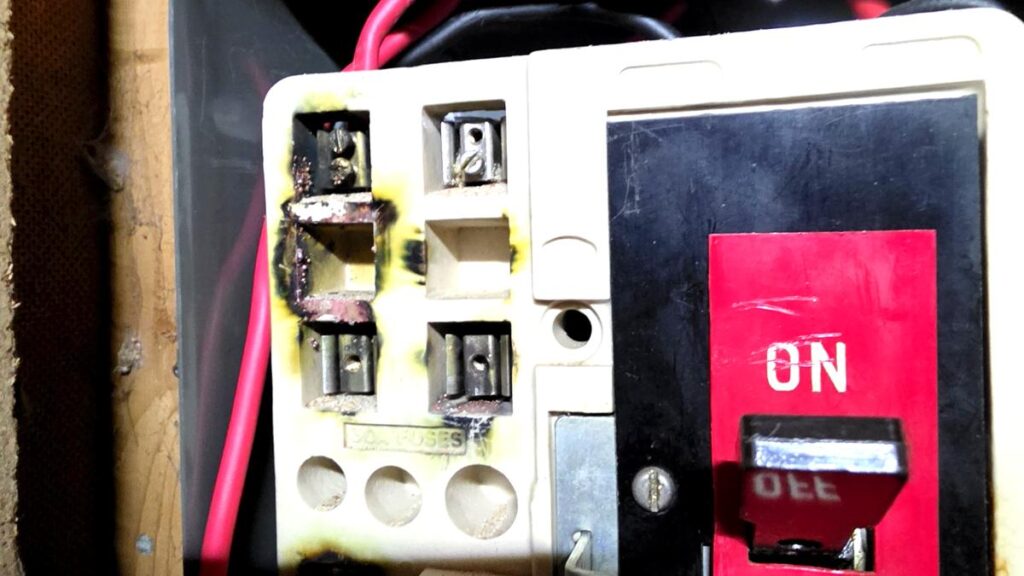 Burnt and damaged old fuse board found during EICR inspection at Aberdeenshire rental property — a C1 immediate danger finding
