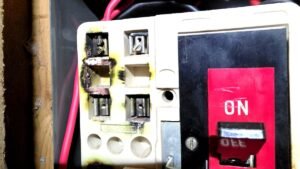Burnt and damaged old fuse board found during EICR inspection at Aberdeenshire rental property — a C1 immediate danger finding