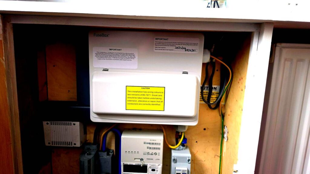A FuseBox consumer unit in a Fraserburgh rental property meter cupboard, showing BS 7671 inspection labels — typical of what an EICR checks in NE Scotland.