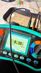 NICEIC electrician carrying out loop impedance test with Kewtech multifunction tester during EICR in Aberdeen