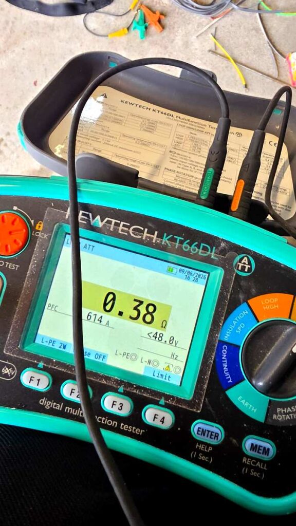 NICEIC electrician carrying out loop impedance test with Kewtech multifunction tester during EICR in Aberdeen