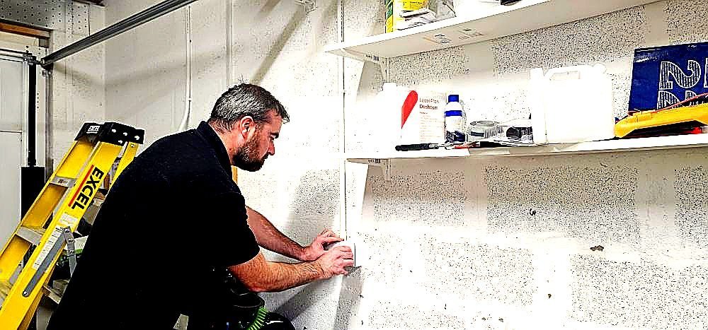 Electrician fitting a socket outlet during a consumer unit upgrade at an Aberdeenshire home
