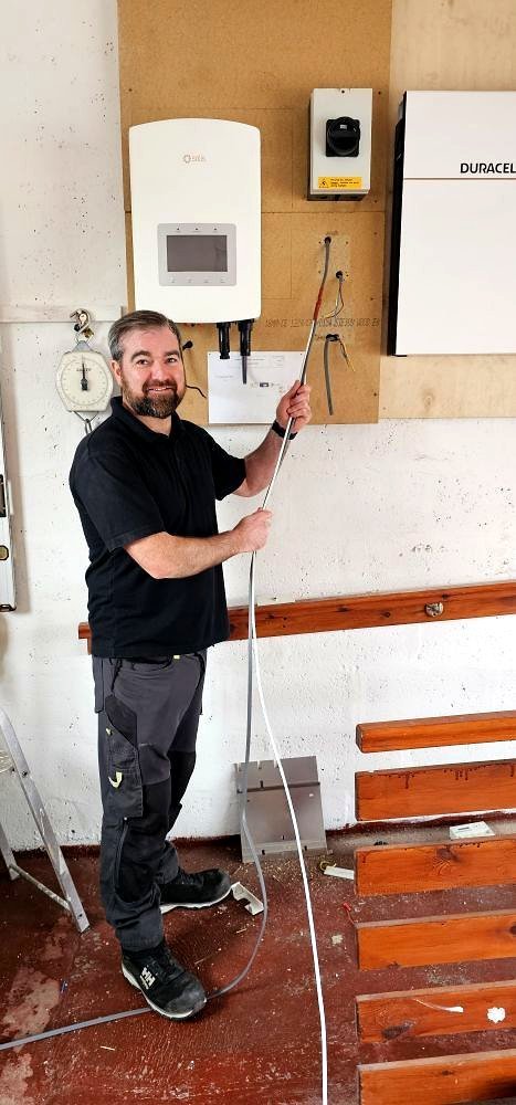 NICEIC electrician wiring a solar inverter and battery in Aberdeenshire
