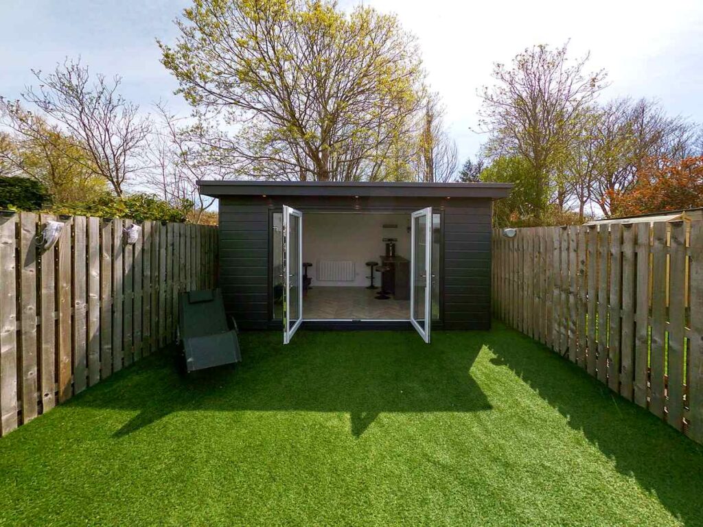 A completed garden room in Aberdeen with full electrical installation by Faithful Spark Electricians — recessed soffit downlights, electric heating, sockets, and SWA armoured cable supply from the house. NICEIC Approved, certified to BS 7671.