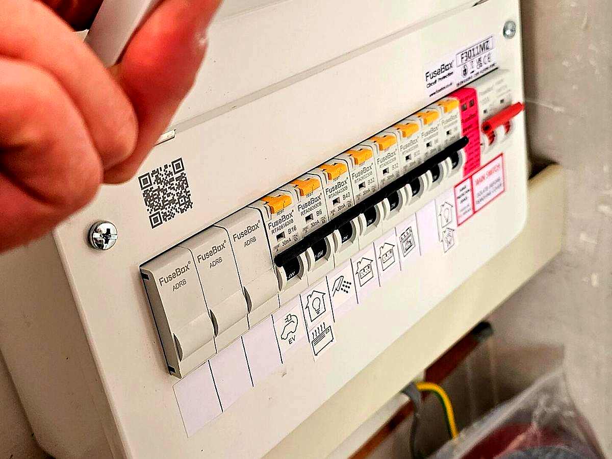 Electrician wiring a dedicated EV charger circuit into a consumer unit in Dyce