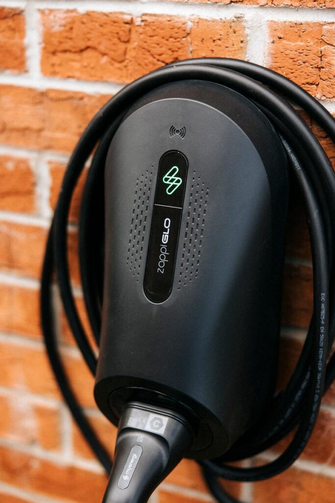 Installed zappi GLO EV charger on brick wall showing green LED active, Aberdeenshire