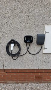 Ohme Home Pro EV charger installed by Faithful Spark Electricians on the exterior wall of an Aberdeen home, with a dedicated EV consumer unit and cable holster