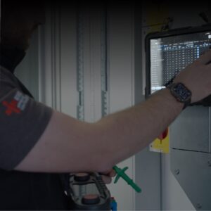 Tradecert electrical certification software open on a site tablet beside a commercial distribution board