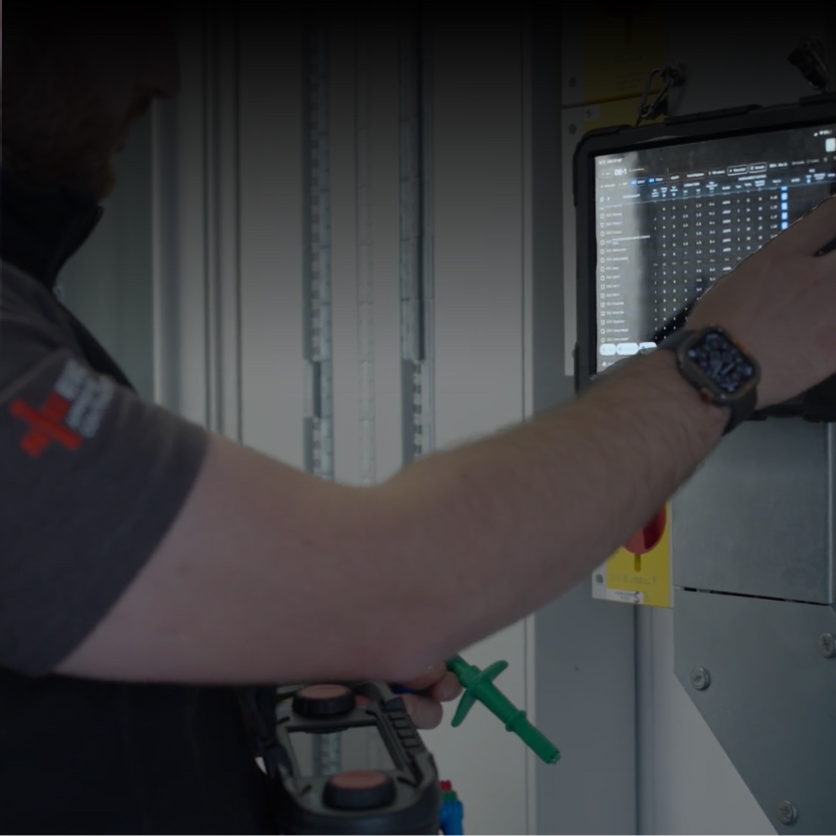 Tradecert electrical certification software open on a site tablet beside a commercial distribution board