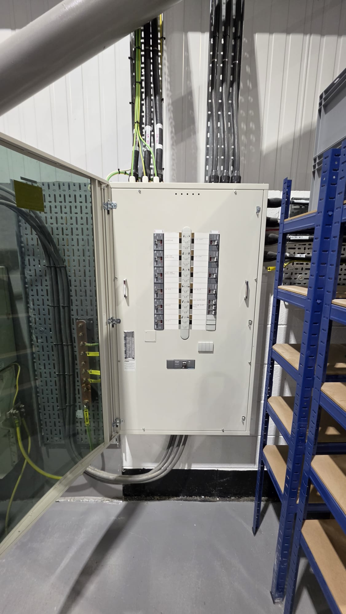 TPN distribution board in an Aberdeen store room with a labelled earth bar and armoured cables on tray, inspected for a commercial EICR
