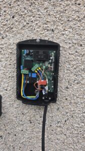Inside a Hypervolt EV charger during installation in Peterhead showing live, neutral and earth terminations