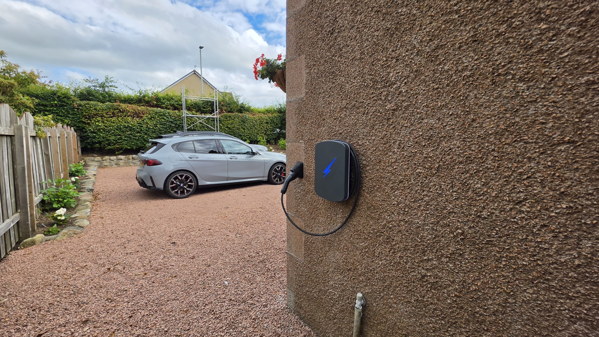 Hypervolt EV charger on a pebbledash gable overlooking a gravel driveway in Kintore, Aberdeenshire