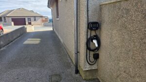 Ohme EV charger with display fitted to a pebbledash wall in a Peterhead side passage