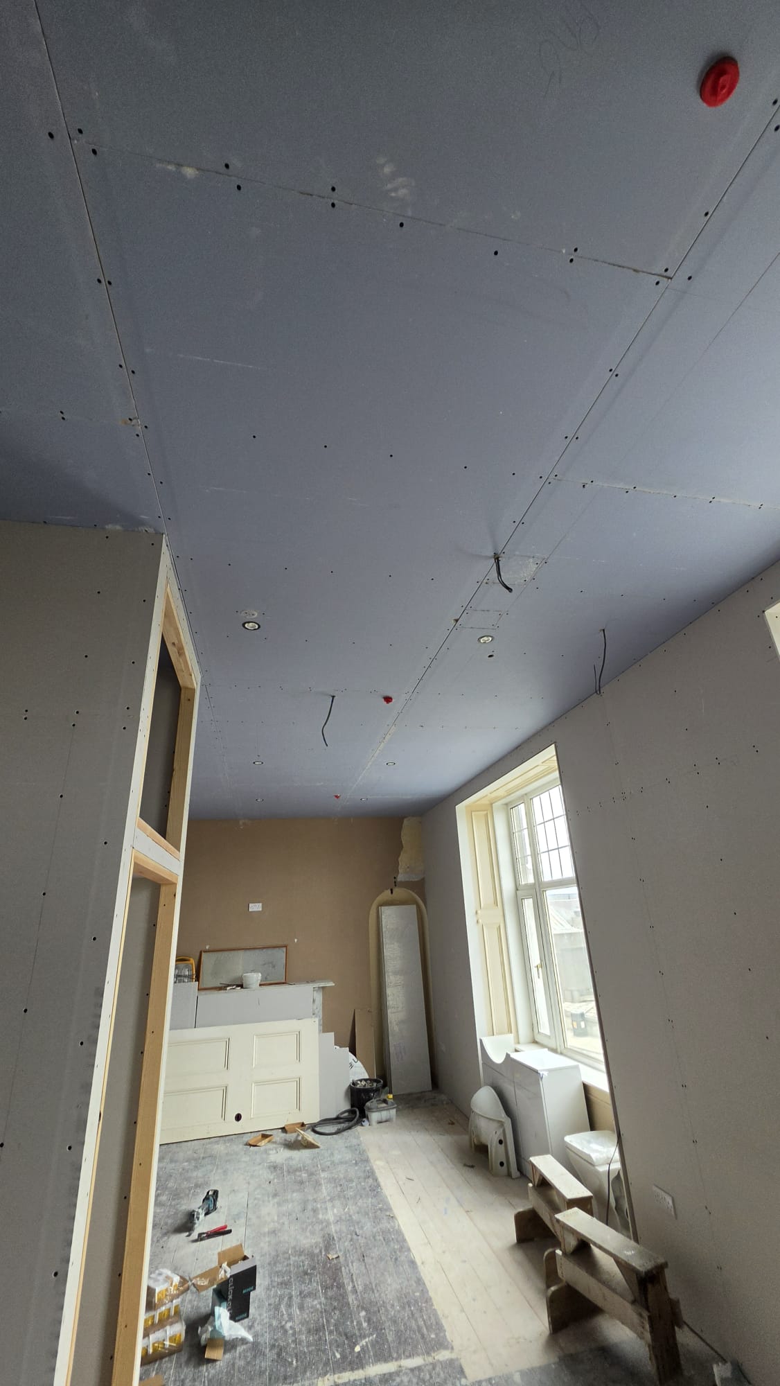Plasterboard ceiling with recessed downlights and wiring tails in a high period room during a Fraserburgh rewire