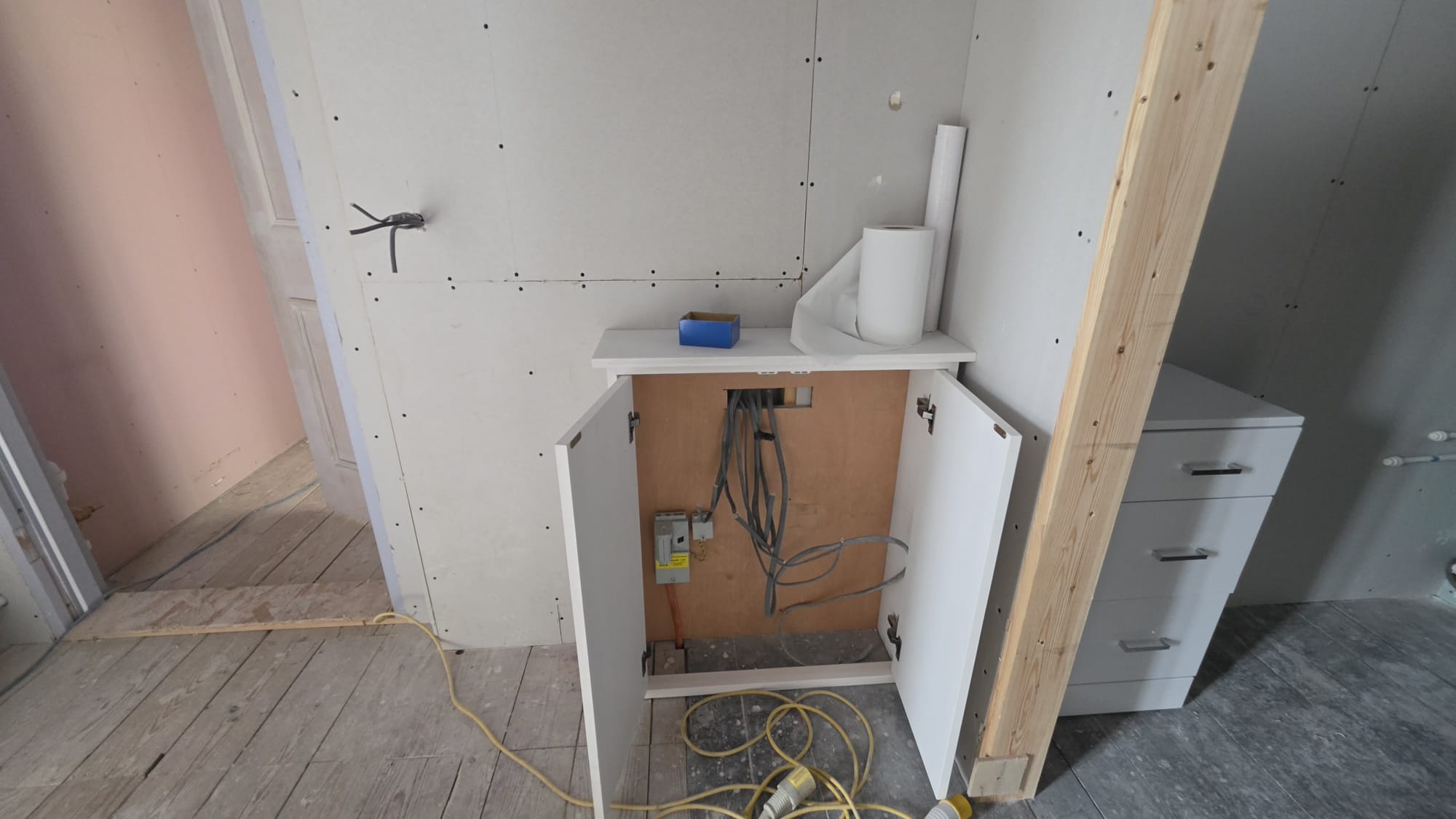 Circuit cables bundled and tied inside an open cupboard during a Fraserburgh rewire